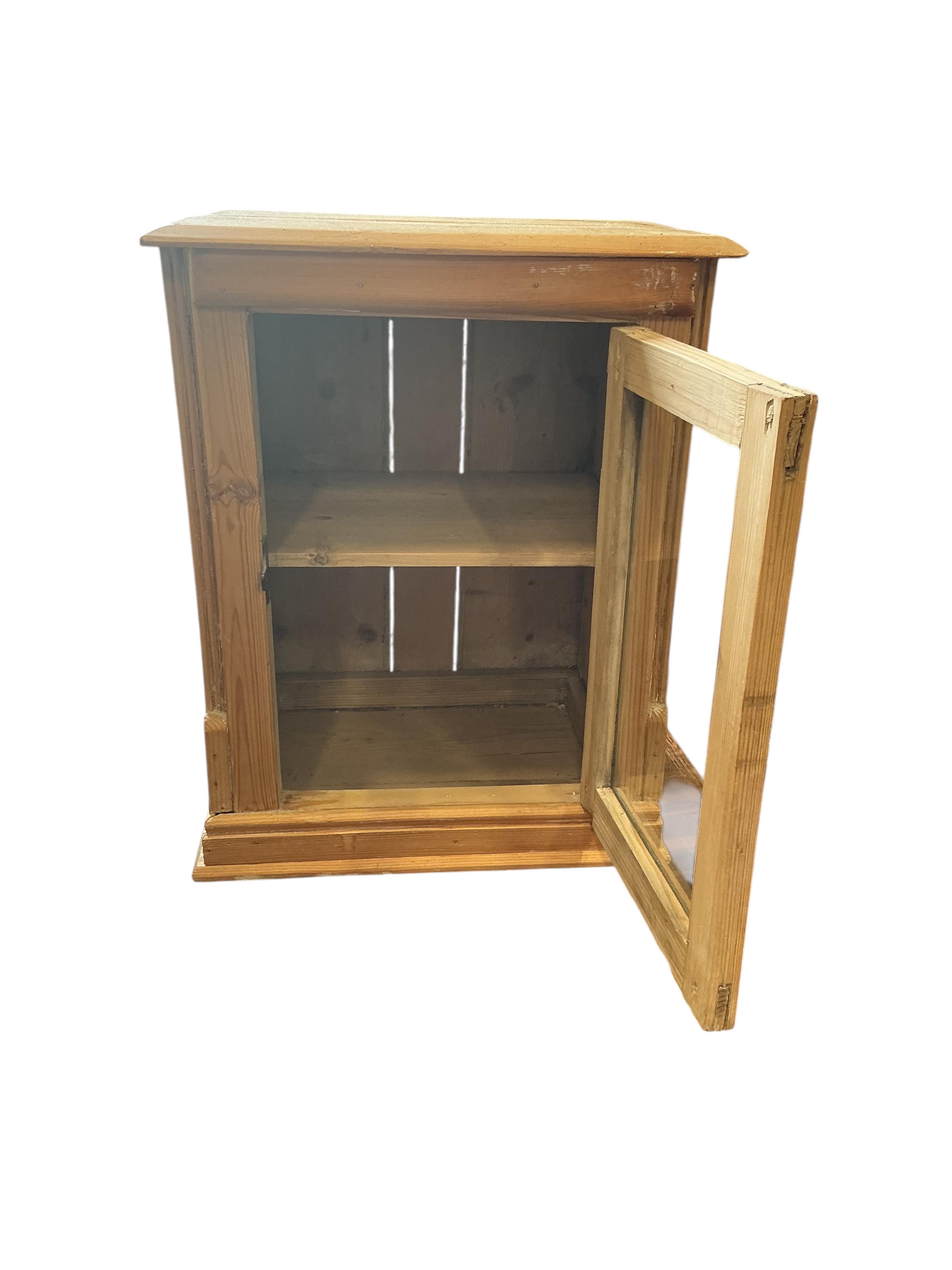 A small 19th century glazed pine table top cabinet, width 37cm, depth 29cm, height 46cm